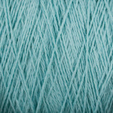 Close-up image of a light blue-colored cone of Homestead 8/2 Cotton Yarn by Supreme Corp, revealing the intricate, intertwined strands that create a textured pattern. The yarn appears soft and slightly fluffy, designed for knitting, crocheting, or other fiber crafts. This machine-washable yarn is perfect for all your creative projects.