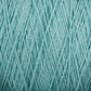 Close-up image of Homestead 8/2 Cotton Yarn | Mini-cone in light blue from Supreme Corp, tightly wound into a ball. The strands of this versatile yarn create a textured and intricate pattern of intertwining fibers across the entire frame. The overall appearance is soft and detailed.