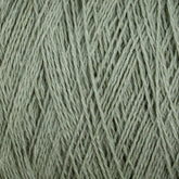 Close-up of the Homestead 8/2 Cotton Yarn | Large Cone by Supreme Corp, a textured, light green yarn showcasing intricate weave patterns and fine fibers. The yarn appears soft and slightly fuzzy, with strands tightly wound together. Plus, it’s machine-washable for added convenience.