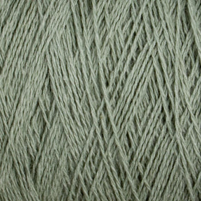 Close-up of the Homestead 8/2 Cotton Yarn | Large Cone by Supreme Corp, a textured, light green yarn showcasing intricate weave patterns and fine fibers. The yarn appears soft and slightly fuzzy, with strands tightly wound together. Plus, it’s machine-washable for added convenience.