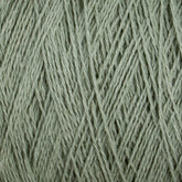 Close-up of light green Homestead 8/2 Cotton Yarn | Mini-cone by Supreme Corp, tightly wound. The texture of the versatile yarn, including the individual fibers and slight variations in color, is clearly visible. The image highlights the fine details and soft, cotton nature of the weaving yarn.