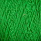 A close-up view of Supreme Corp's Homestead 8/2 Cotton Yarn on a mini-cone reveals bright green, machine-washable strands tightly wound together, creating a textured and detailed pattern. The fibers intersect and overlap, forming an intricate web of thread lines.