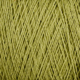 Close-up view of Supreme Corp's light green Homestead 8/2 Cotton Yarn on a large cone, showcasing the intricate pattern of interwoven fibers. The texture appears soft and slightly fibrous, with the strands crisscrossing diagonally across the image, perfect for those seeking both beauty and machine-washable durability.