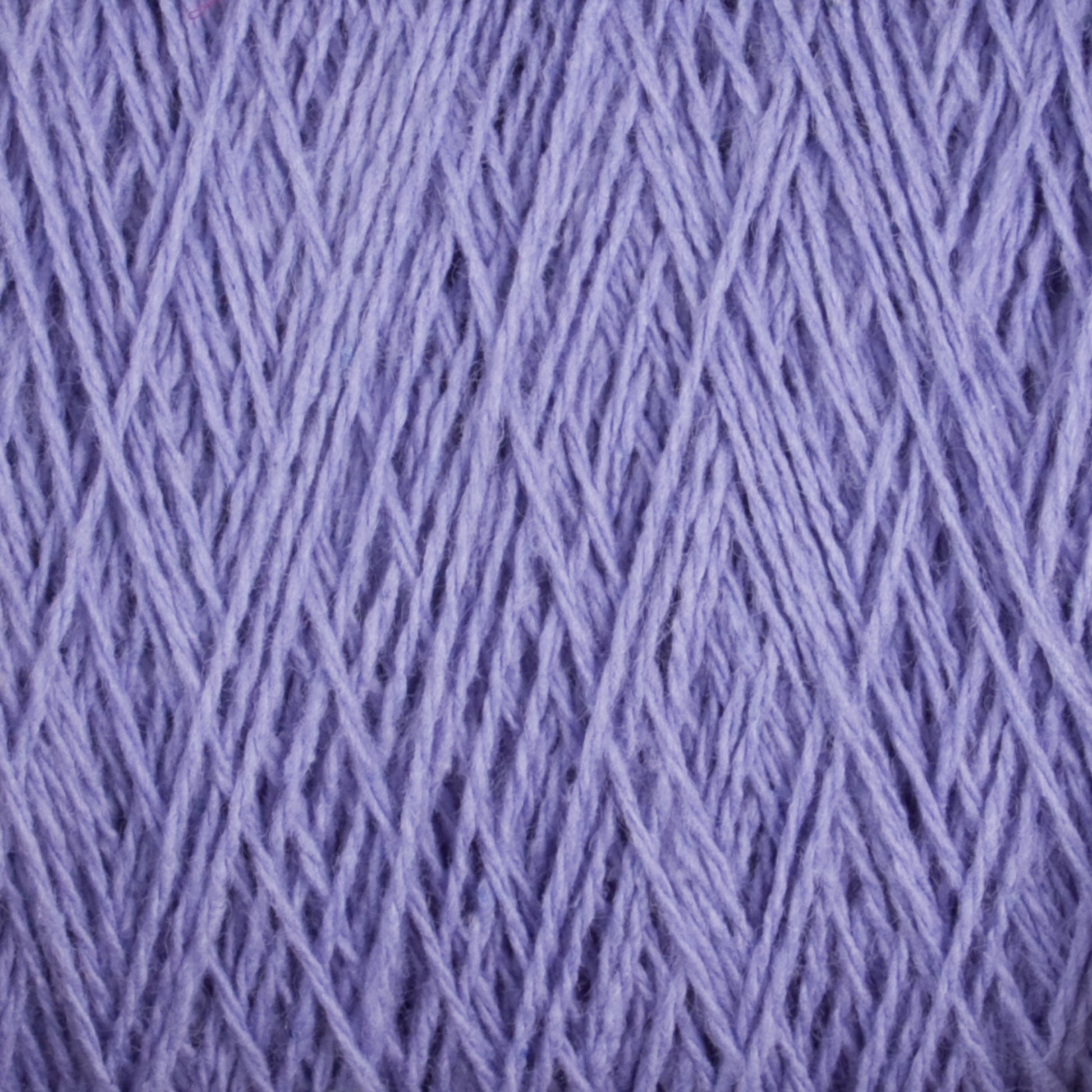 Close-up of lilac-colored Homestead 8/2 Cotton Yarn | Large Cone by Supreme Corp, with multiple strands intricately woven together. The texture appears soft with a slightly fuzzy surface, showcasing the fine threads and the uniform, tight pattern of the weave. The machine-washable yarn fills the entire frame.