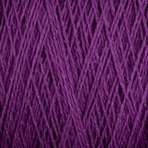 Close-up of a ball of deep purple Homestead 8/2 Cotton Yarn from Supreme Corp, showing the tightly wound fibers in a crisscross pattern. The texture is slightly fuzzy, with individual strands that are thin and closely packed together. This luxurious, machine-washable yarn on a large cone is perfect for all your weaving projects.