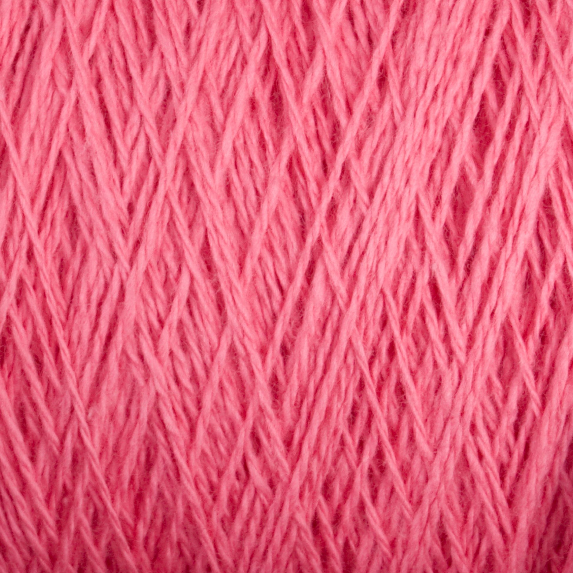 Close-up view of the textured Homestead 8/2 Cotton Yarn by Supreme Corp. The individual strands are neatly interwoven, showcasing intricate fiber details. The image highlights the softness and fine quality of this pink weaving yarn on a large cone.