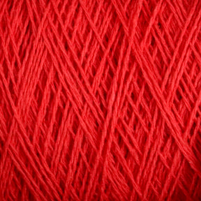 Close-up image showing the intricate and detailed texture of tightly wound Homestead 8/2 Cotton Yarn | Large Cone from Supreme Corp. The fibers of this machine-washable yarn are arranged in a crisscross pattern, highlighting the different shades and thicknesses of the red strands.