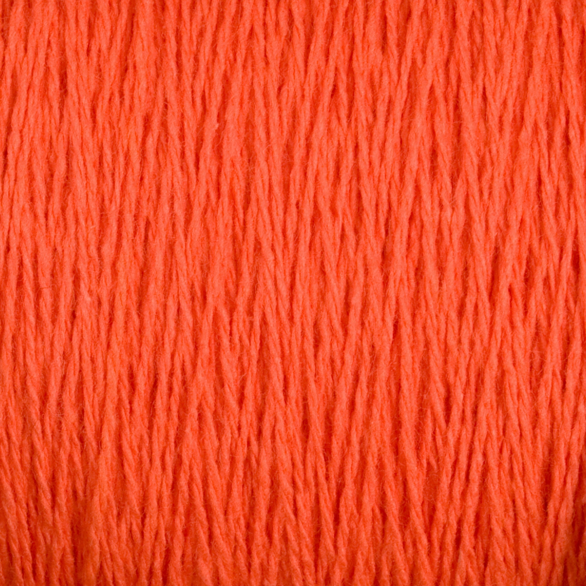 Close-up image of Supreme Corp's Homestead 8/2 Cotton Yarn | Mini-cone in bright orange, showcasing the texture and detail of the individual strands intertwined together. This versatile yarn appears soft and thick, making it ideal for both knitting and crocheting. The background is completely filled with yarn, emphasizing its vivid color.