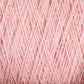 A close-up view of a ball of Homestead 8/2 Cotton Yarn in soft pink from Supreme Corp, showcasing the intricate overlapping strands and texture. The threads are neatly wound on the large cone, creating a linear pattern. The gentle pink color exudes warmth and softness, making it perfect for all your weaving projects.