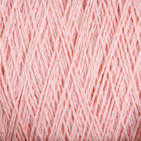 A close-up view of a ball of Homestead 8/2 Cotton Yarn in soft pink from Supreme Corp, showcasing the intricate overlapping strands and texture. The threads are neatly wound on the large cone, creating a linear pattern. The gentle pink color exudes warmth and softness, making it perfect for all your weaving projects.