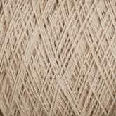 Close-up image of a ball of beige, machine-washable yarn from Supreme Corp's Homestead 8/2 Cotton Yarn | Mini-cone. The intricate overlapping strands showcase a soft and slightly fuzzy texture, highlighting the interwoven fibers in a neutral, light tan color.