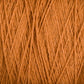 Close-up image of Homestead 8/2 Cotton Yarn | Mini-cone by Supreme Corp. The texture and detailed strands of the weaving yarn are visible, showing a tightly wound pattern. This orange yarn has a soft and slightly fuzzy appearance, highlighting the individual fibers as they intertwine, making it one of the most versatile yarns available.