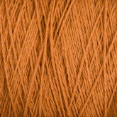 Close-up image of Homestead 8/2 Cotton Yarn | Mini-cone by Supreme Corp. The texture and detailed strands of the weaving yarn are visible, showing a tightly wound pattern. This orange yarn has a soft and slightly fuzzy appearance, highlighting the individual fibers as they intertwine, making it one of the most versatile yarns available.