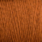 Close-up image of a spool of Homestead 8/2 Cotton Yarn | Mini-cone by Supreme Corp. The texture and individual strands of this versatile yarn are clearly visible, showcasing its fibrous and woven structure. The rich brown color is consistent throughout, providing a warm and earthy appearance perfect for various weaving projects.