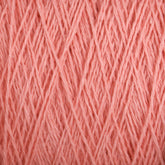 Close-up of Supreme Corp's Homestead 8/2 Cotton Yarn in pink, revealing strands intertwined to form a dense and textured pattern. The yarn is soft and finely spun, with threads crisscrossing each other to create an intricate and detailed fabric-like surface that is conveniently machine-washable.