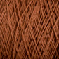 Close-up texture of tightly wound Homestead 8/2 Cotton Yarn in brown from Supreme Corp with multiple overlapping strands creating a crisscross pattern. The threads have a soft, fibrous appearance, and the overall image highlights the intricate detail of this versatile yarn's weave on a mini-cone.