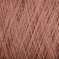 A close-up view of a bundle of Supreme Corp's Homestead 8/2 Cotton Yarn on a large cone in a dusty pink color. The strands are tightly wound, creating a textured and slightly fuzzy appearance. This yarn, ideal for weaving projects, showcases intricate fibrous details and the rich, soft hue that is also machine-washable.