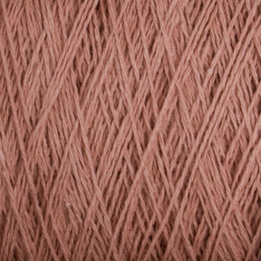 A close-up view of a bundle of Supreme Corp's Homestead 8/2 Cotton Yarn on a large cone in a dusty pink color. The strands are tightly wound, creating a textured and slightly fuzzy appearance. This yarn, ideal for weaving projects, showcases intricate fibrous details and the rich, soft hue that is also machine-washable.