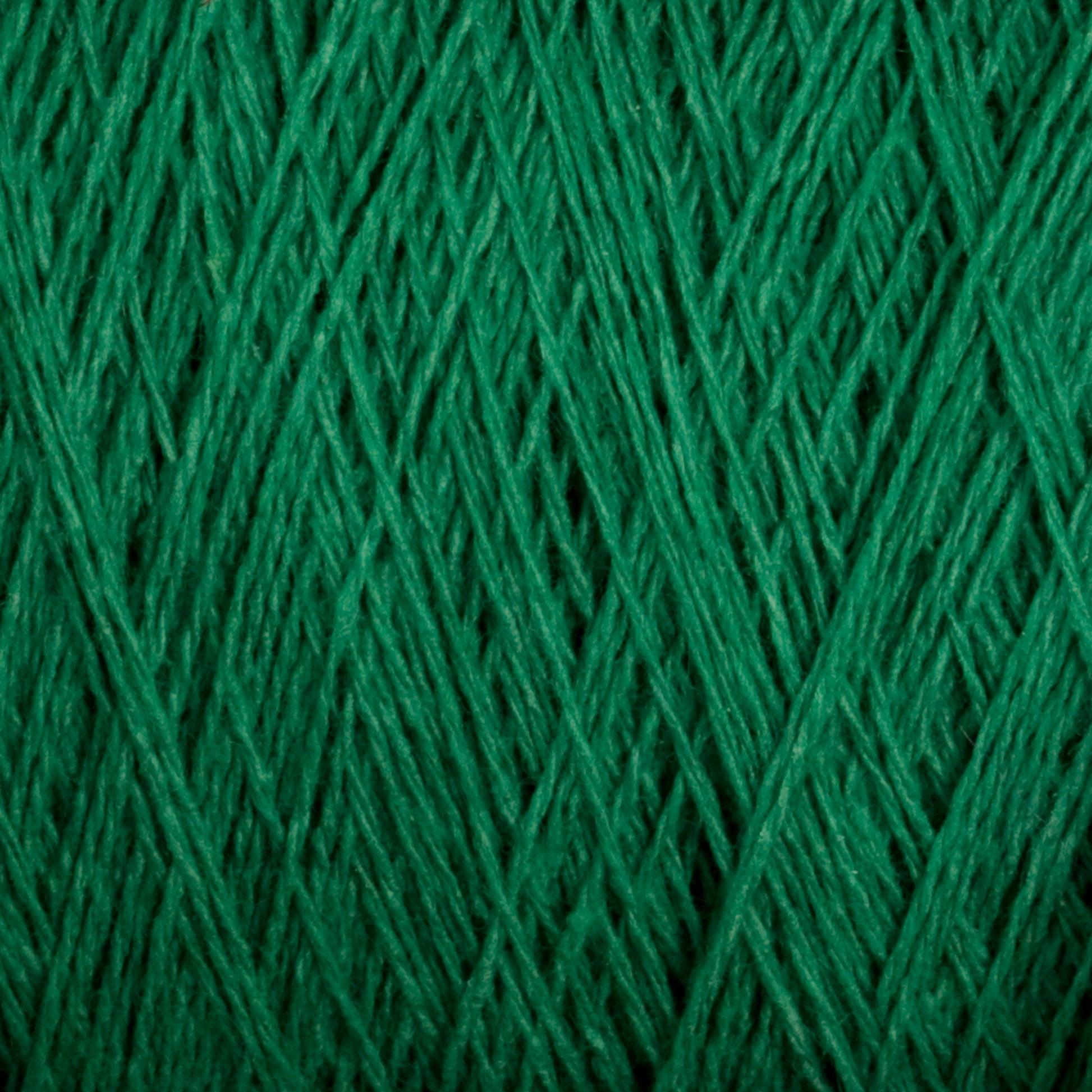 Close-up of Homestead 8/2 Cotton Yarn | Mini-cone by Supreme Corp in a neat, crisscross pattern, forming a textured surface. The fibers are tightly wound, creating an intricate look perfect for weaving projects or knitting with versatile yarns. The vibrant green color stands out prominently.