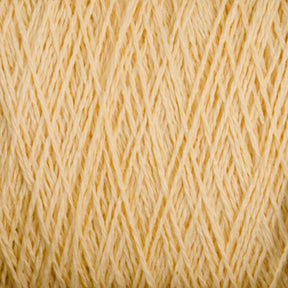 A close-up image of tightly wound, pale yellow Homestead 8/2 Cotton Yarn from Supreme Corp. The strands are uniformly arranged and showcase a soft, textured appearance, suitable for knitting or crafting. This machine-washable yarn features a consistent color throughout, giving it a warm, creamy look.