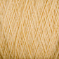 Close-up image of a ball of Homestead 8/2 Cotton Yarn | Mini-cone by Supreme Corp, machine-washable and tightly wound in diagonal layers, showcasing the texture of the fibers. The yarn boasts a soft, fuzzy appearance with a warm, cream-colored neutral tone.