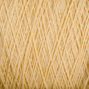 Close-up image of a ball of Homestead 8/2 Cotton Yarn | Mini-cone by Supreme Corp, machine-washable and tightly wound in diagonal layers, showcasing the texture of the fibers. The yarn boasts a soft, fuzzy appearance with a warm, cream-colored neutral tone.