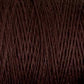 Close-up of dark brown Homestead 8/2 Cotton Yarn by Supreme Corp, wound tightly on a large cone. The texture of the yarn is beautifully detailed, showcasing individual fibers and strands woven together intricately.