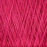 Close-up image of tightly wound Homestead 8/2 Cotton Yarn | Mini-cone by Supreme Corp, showcasing its fine, smooth texture and vibrant pink color. The versatile yarn strands are neatly aligned, forming a pattern of intersecting lines and soft shadows, and it is machine-washable for added convenience.