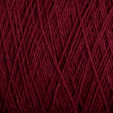 Close-up image of deep maroon, machine-washable Homestead 8/2 Cotton Yarn by Supreme Corp, tightly wound with visible strands and fibers. The texture showcases intricate details of the individual threads crossing and interweaving, forming a dense and uniform pattern.