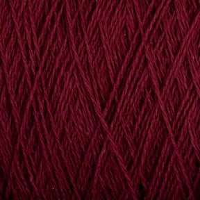 Close-up image of deep maroon, machine-washable Homestead 8/2 Cotton Yarn by Supreme Corp, tightly wound with visible strands and fibers. The texture showcases intricate details of the individual threads crossing and interweaving, forming a dense and uniform pattern.