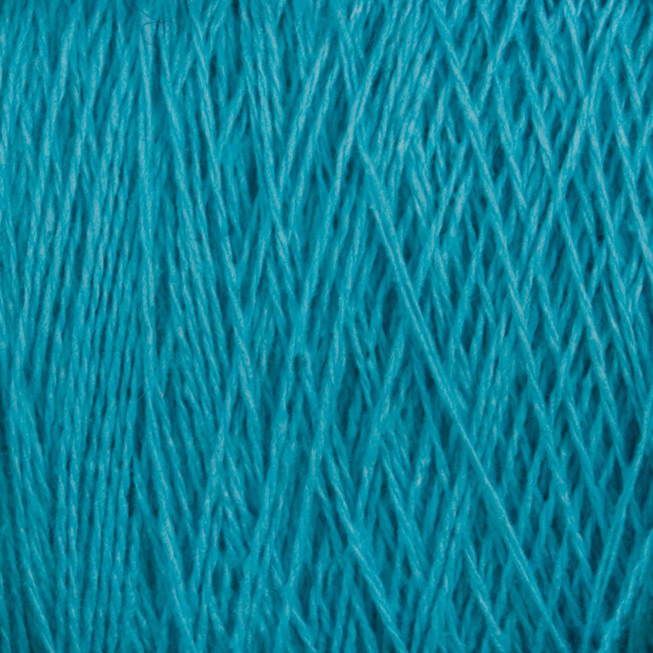 Close-up of a spool of Homestead 8/2 Cotton Yarn in bright blue from Supreme Corp. The fibers are tightly wound together, showcasing the texture and detail of the strands. The vibrant color and intricate pattern of this machine-washable weaving yarn create a visually appealing and textured appearance, ideal for any project.