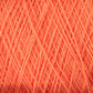 Close-up image of orange Homestead 8/2 Cotton Yarn | Large Cone by Supreme Corp, intricately layered, creating a textured pattern. The strands are thin, tightly intertwined, and evenly spaced, showcasing the detailed structure of the weaving yarn. Plus, it's machine-washable for easy care.