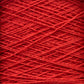 A close-up image of red Homestead 8/2 Cotton Yarn | Large Cone by Supreme Corp wound around itself, creating a textured and crisscrossing pattern. The machine-washable strands are tightly coiled, showcasing the fiber's intricate and uniform arrangement.