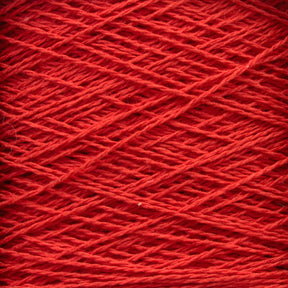 A close-up image of red Homestead 8/2 Cotton Yarn | Large Cone by Supreme Corp wound around itself, creating a textured and crisscrossing pattern. The machine-washable strands are tightly coiled, showcasing the fiber's intricate and uniform arrangement.