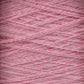 Close-up image of light pink Homestead 8/2 Cotton Yarn | Large Cone by Supreme Corp, showcasing its soft texture and intricately wound strands. The yarn features a subtle sheen, with fibers running at varying angles, highlighting the layers and depth of this machine-washable material.