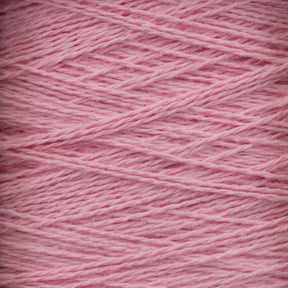 Close-up image of light pink Homestead 8/2 Cotton Yarn | Large Cone by Supreme Corp, showcasing its soft texture and intricately wound strands. The yarn features a subtle sheen, with fibers running at varying angles, highlighting the layers and depth of this machine-washable material.