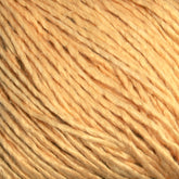 Close-up image of a ball of Halcyon Yarn's Gemstone Soft Twist Silk Yarn, displaying smooth, slightly twisted fibers in a consistent light beige color. The texture appears soft throughout.