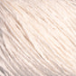 Close-up of Halcyon Yarn's Gemstone Soft Twist Silk Yarn, showcasing its soft, off-white thickness wound into a skein. The yarn exhibits a slight sheen with visible twisted fibers, providing it with a textured and cozy appearance reminiscent of fine gemstone silks.