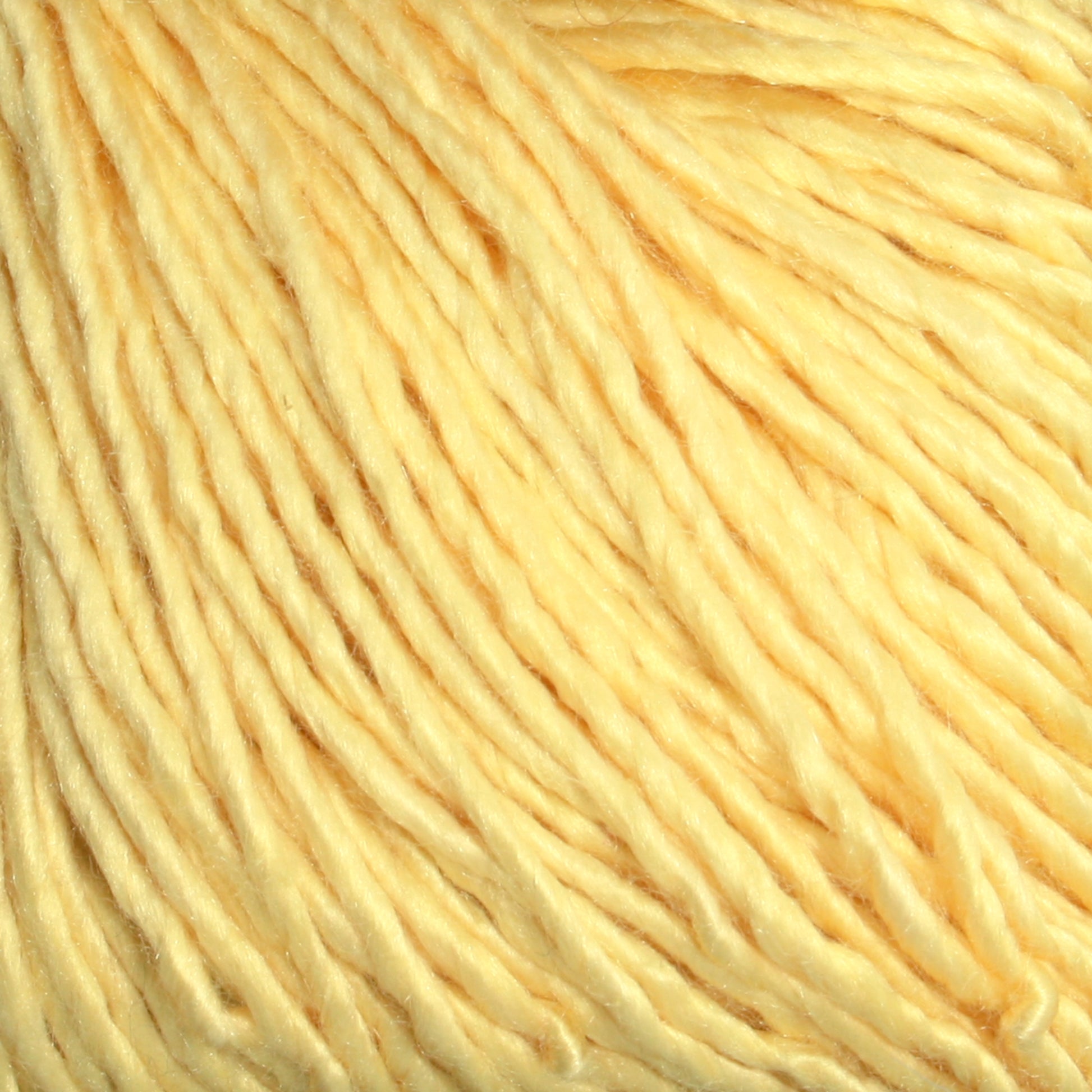 Close-up of Halcyon Yarn's Gemstone Soft Twist Silk Yarn strands arranged neatly, showcasing their visible texture and slight sheen.