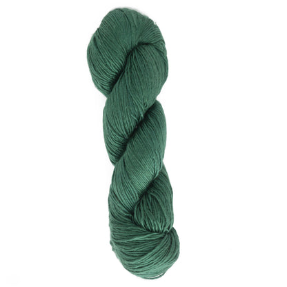 A skein of Halcyon Yarn's Gemstone Soft Twist Silk Yarn, in dark green, is coiled neatly, forming an elongated oval shape. The 100% silk yarn has a smooth texture and is tightly twisted, showcasing its thickness and soft fibers against a solid white background.