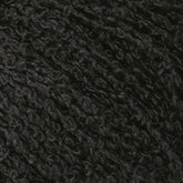 Close-up image of Gemstone Silk Bouclé. The black, curly wool texture showcases densely packed fibers, forming a wavy and intricate pattern that mirrors Halcyon Yarn's finest creations. The surface looks soft and plush, highlighting the natural, coarse details inherent in the wool's structure.