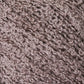 Close-up image of Halcyon Yarn's Gemstone Silk Bouclé in a light purple color, showcasing a soft, textured yarn with a curly, intertwined fiber pattern.