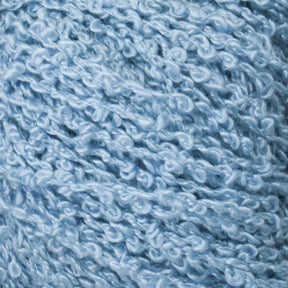 Close-up view of Gemstone Silk Bouclé in light blue, featuring a textured yarn with a curly, bouclé appearance. This Halcyon Yarn has a soft and fluffy texture, showcasing its intricate loops and twists.