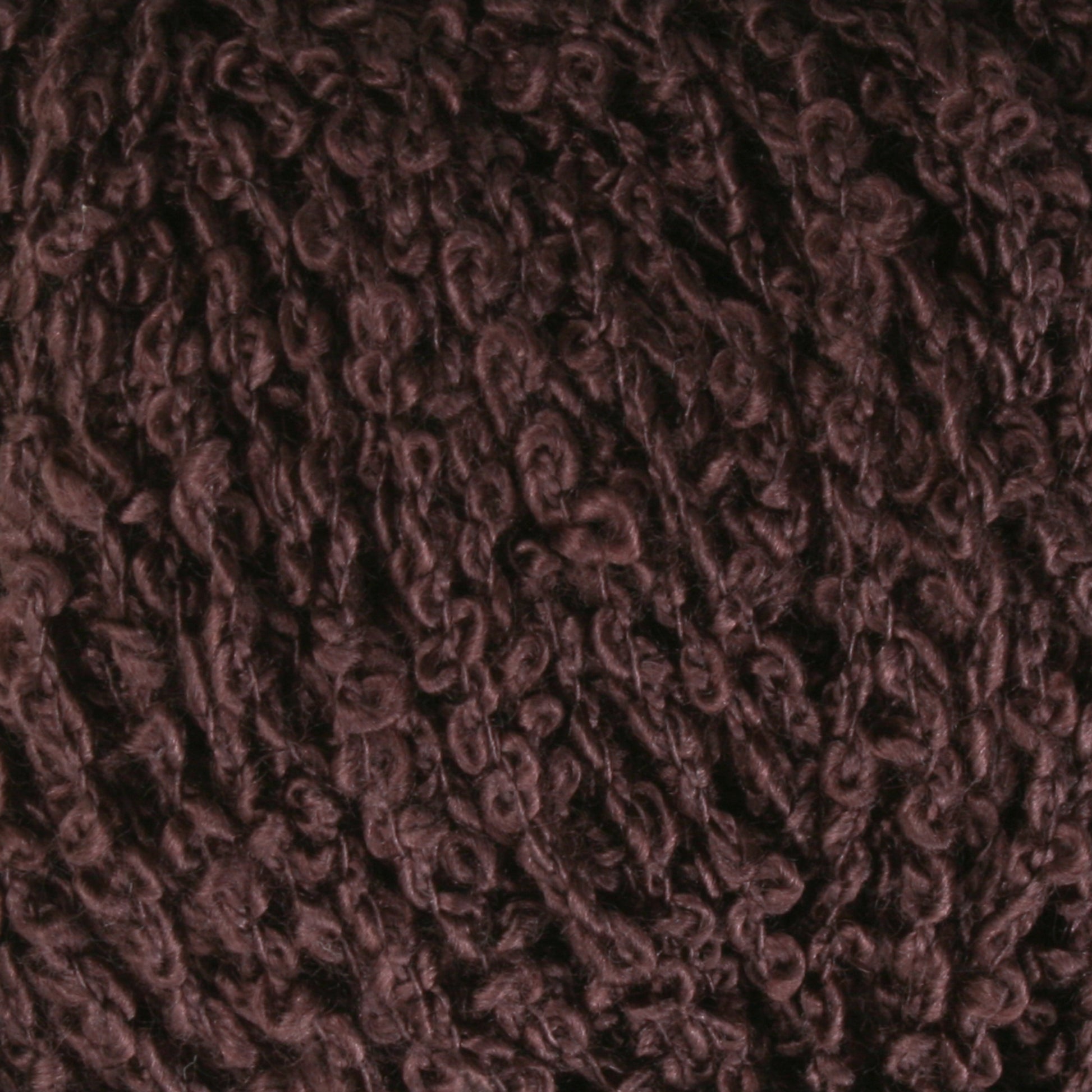 Close-up image of Halcyon Yarn's Gemstone Silk Bouclé, showcasing its dark brown textured fibers in a beautifully knitted loop pattern. The thick and soft appearance of the yarn makes it ideal for knitting or crafting projects.