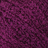 Close-up of Halcyon Yarn's Gemstone Silk Bouclé. The surface appears soft and fluffy with tightly wound fibers creating a rich, intricate pattern. Reminiscent of Gemstone Silk Bouclé, the deep hue of the purple adds to the detail and depth of the material.