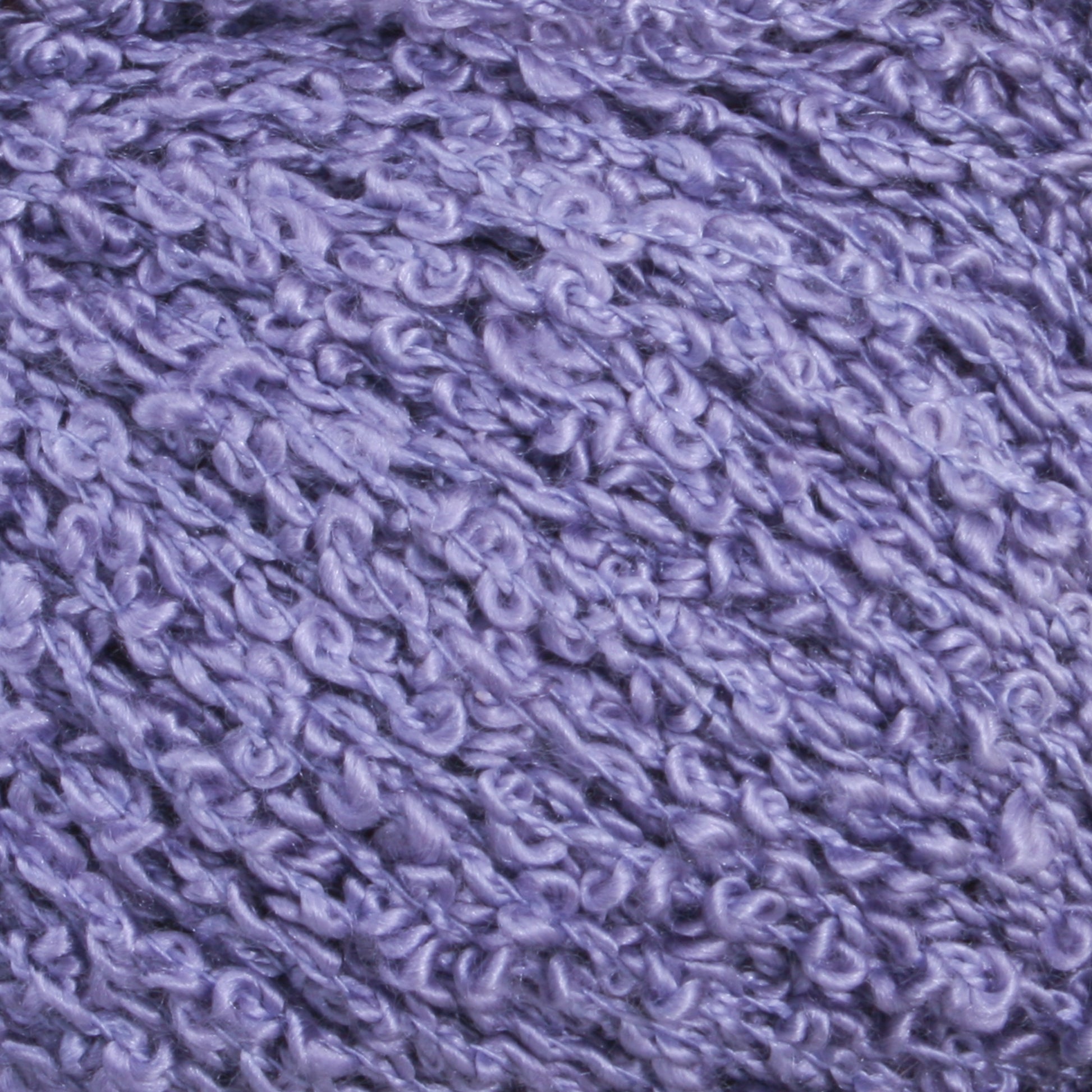 Close-up image of soft, textured purple yarn with a bouclé appearance. The Gemstone Silk Bouclé by Halcyon Yarn features small loops, creating a bumpy and fluffy texture, ideal for knitting or crocheting cozy garments and accessories.