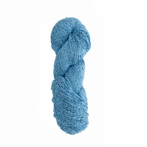 A twisted skein of textured blue yarn is displayed against a plain white background. The yarn has a slightly bumpy surface, indicating it is a boucle type, suitable for knitting or crocheting projects that require a softer, more tactile fabric. This Gemstone Silk Bouclé from Halcyon Yarn promises luxury in every stitch.