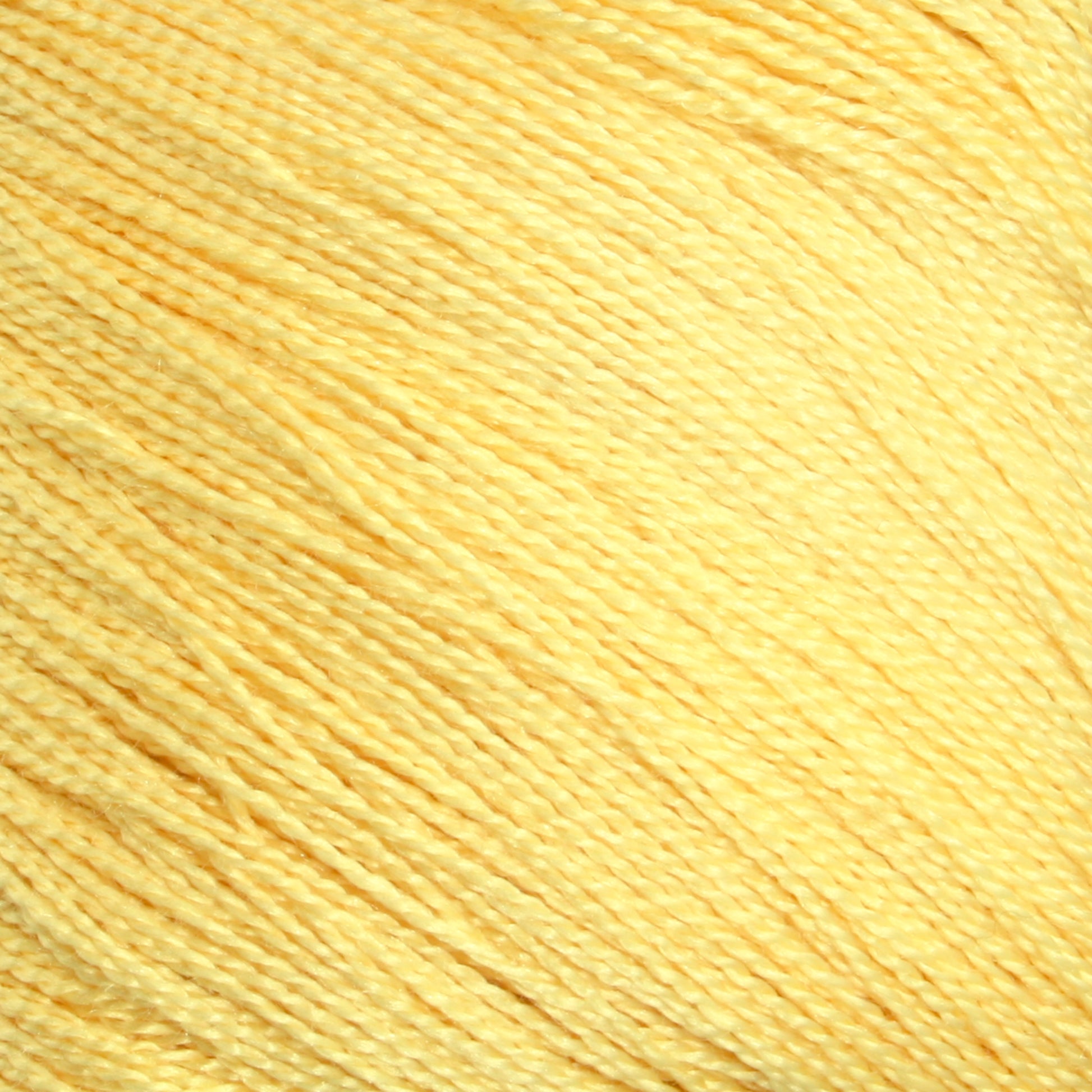 A close-up image of Halcyon Yarn's Gemstone Silk 2/30 in a soft yellow shade, showcasing its individual strands and smooth texture. The yarn is neatly wound, featuring a uniform color and slight sheen that hints at its luxurious silk composition.