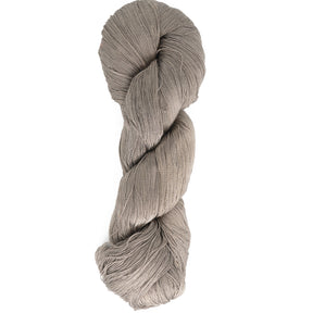 A skein of Halcyon Yarn's Gemstone Silk 2/30 in light grey is twisted neatly into a hank. This silk yarn appears soft and smooth, making it suitable for knitting or crochet projects. The plain white background highlights the texture and color of the weaving silk.