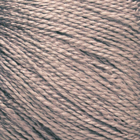 A close-up image of tightly wound Gemstone Silk 2/12 yarn in a beige hue from Halcyon Yarn. The twisted strands create a textured appearance with a slight sheen under the light, highlighting the detailed and intricate composition of the fibers, making it ideal for weaving or knitting luxurious projects.